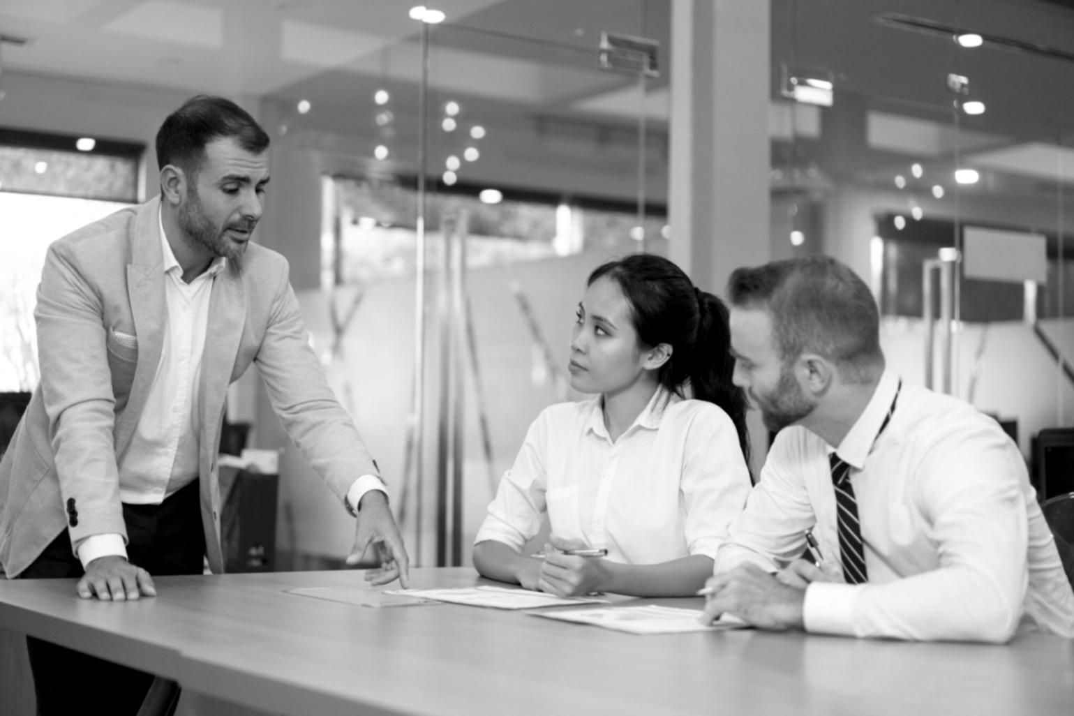Professional partnership meeting discussing budget negotiation strategies